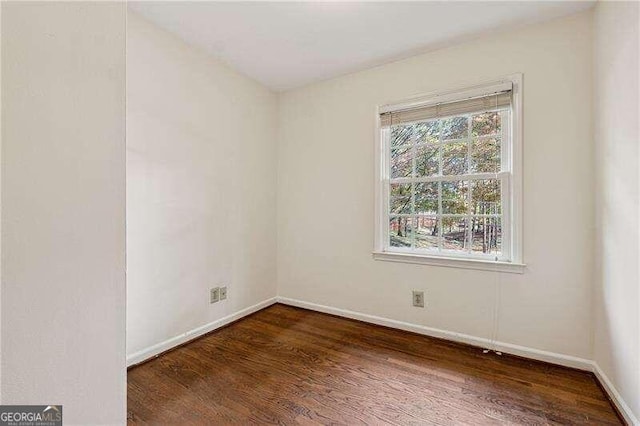 empty room featuring dark wood-type flooring