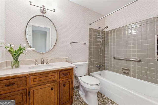 full bathroom with tile patterned flooring, vanity, tiled shower / bath combo, and toilet