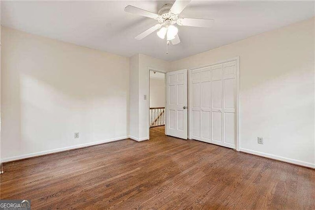 unfurnished bedroom featuring dark hardwood / wood-style flooring, a closet, and ceiling fan