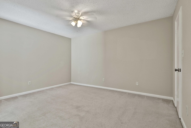 unfurnished room featuring ceiling fan, a textured ceiling, and light carpet