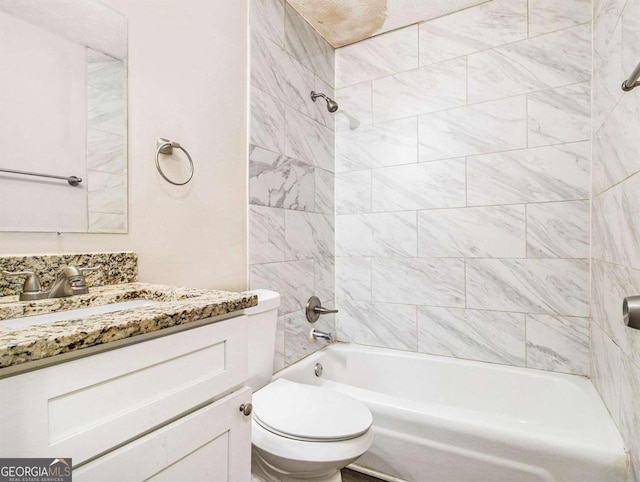 full bathroom featuring vanity, tiled shower / bath combo, and toilet