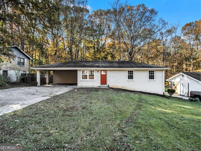 view of front of house with a front lawn and a carport