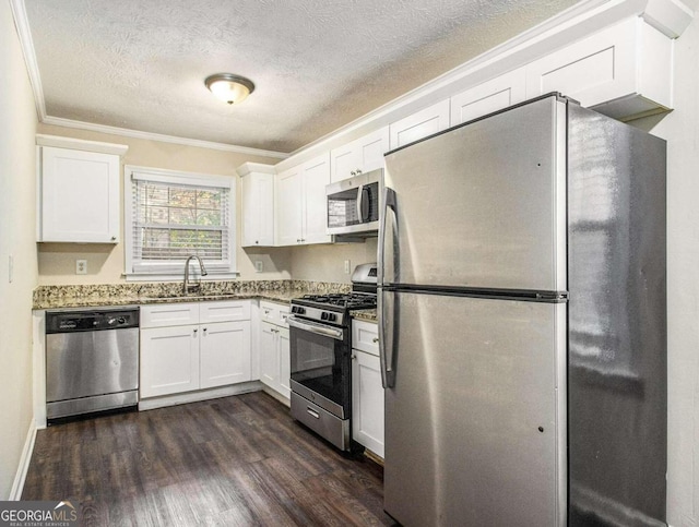 3811 Paul St, Douglasville, GA 30135 - kitchen with appliances with stainless steel finishes, a sink, ornamental molding, a textured ceiling, and white cabinetry