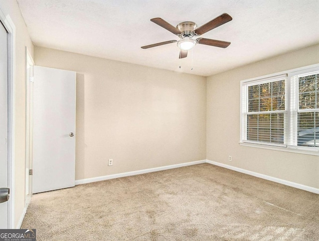 carpeted empty room with a textured ceiling and ceiling fan