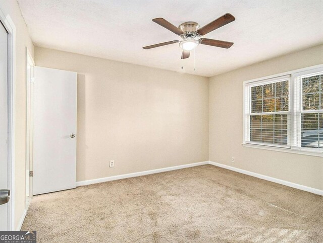 3811 Paul St, Douglasville, GA 30135 - spare room featuring carpet, baseboards, and a ceiling fan