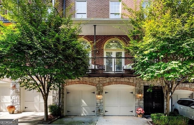 view of front of home with a balcony and a garage