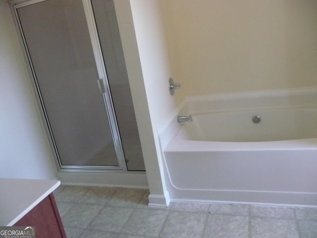 bathroom featuring shower with separate bathtub