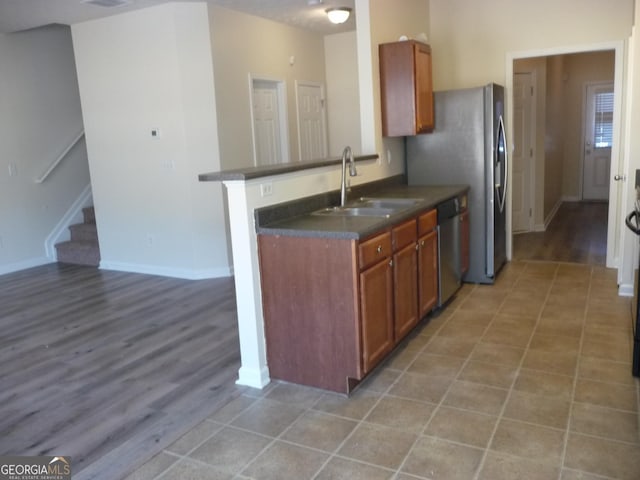 kitchen with sink, dishwasher, and kitchen peninsula