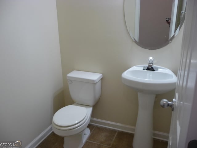 bathroom featuring toilet and tile patterned floors