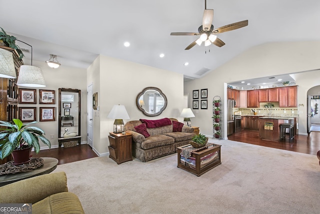 living room featuring ceiling fan, dark hardwood / wood-style flooring, and lofted ceiling