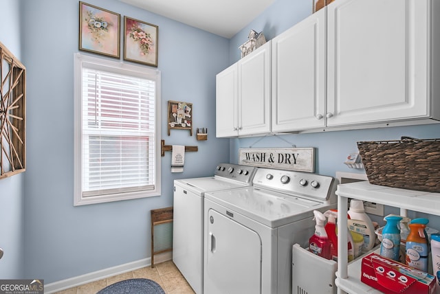 washroom featuring cabinets, washing machine and dryer, and light tile patterned floors