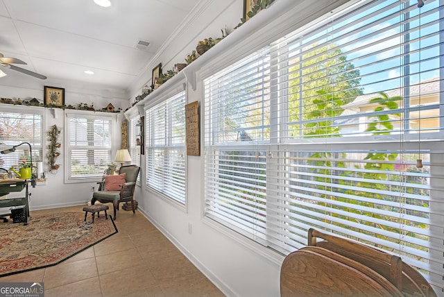 sunroom / solarium with ceiling fan and a healthy amount of sunlight