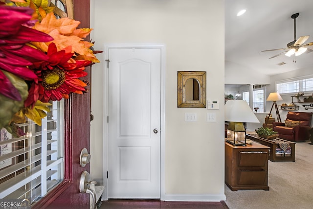 entryway with carpet flooring, ceiling fan, and vaulted ceiling