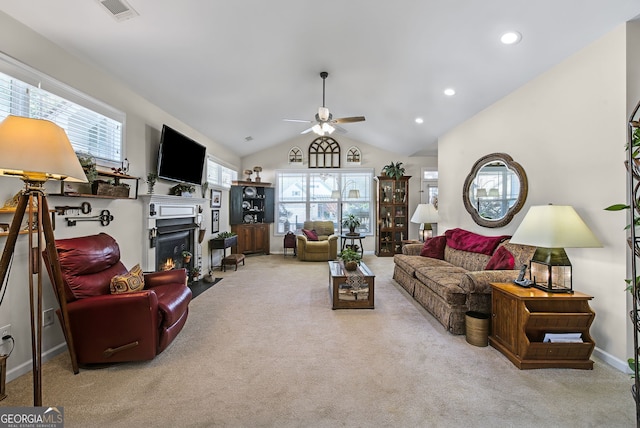 carpeted living room with ceiling fan and lofted ceiling