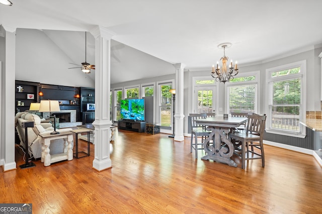 dining space with ceiling fan with notable chandelier, a healthy amount of sunlight, crown molding, and light hardwood / wood-style flooring