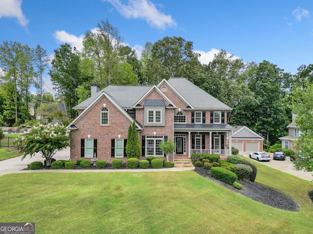 view of front of property with covered porch and a front yard