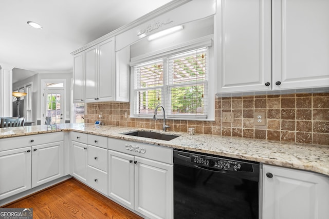 kitchen featuring plenty of natural light, sink, white cabinetry, and black dishwasher