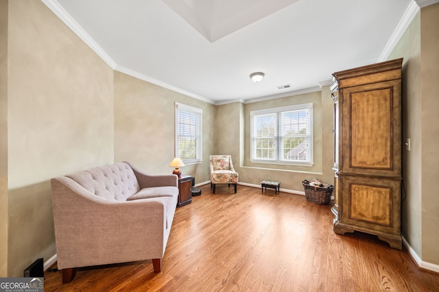 sitting room featuring hardwood / wood-style floors and crown molding