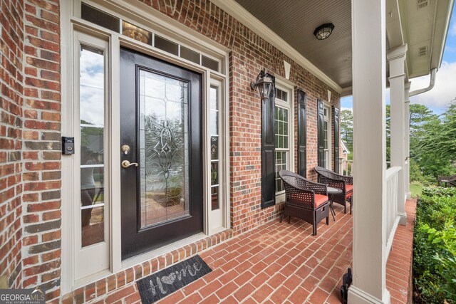 doorway to property featuring covered porch