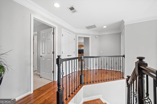 hallway with hardwood / wood-style flooring and crown molding