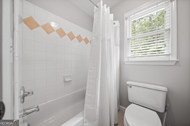 bathroom with toilet and shower / bath combo with shower curtain