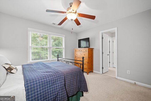 bedroom with ceiling fan and light carpet