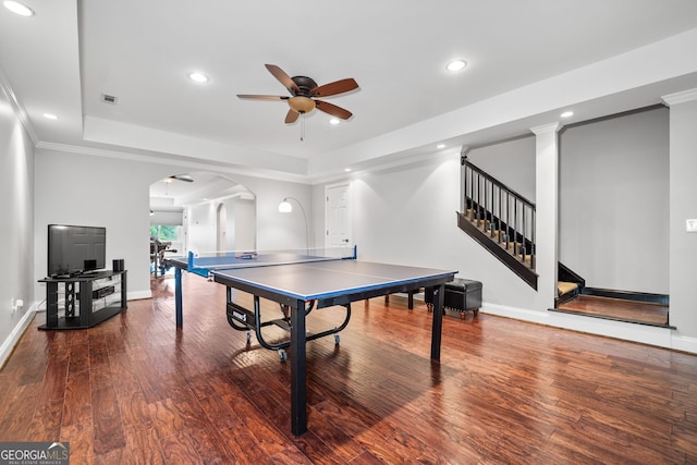 rec room with wood-type flooring, a tray ceiling, ceiling fan, and ornamental molding