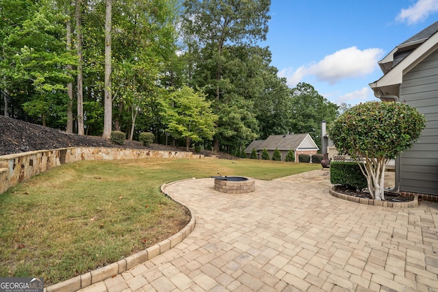 view of yard featuring a fire pit and a patio area