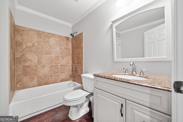 full bathroom featuring vanity, wood-type flooring, tiled shower / bath combo, and ornamental molding