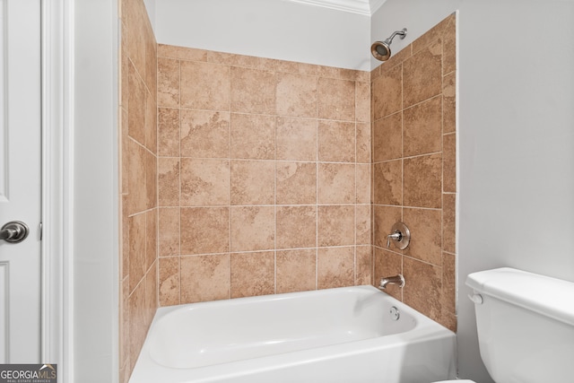 bathroom with tiled shower / bath combo and toilet