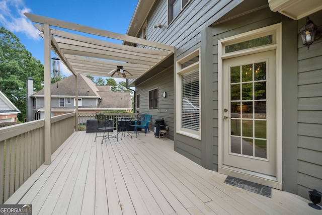 wooden terrace with ceiling fan and a pergola