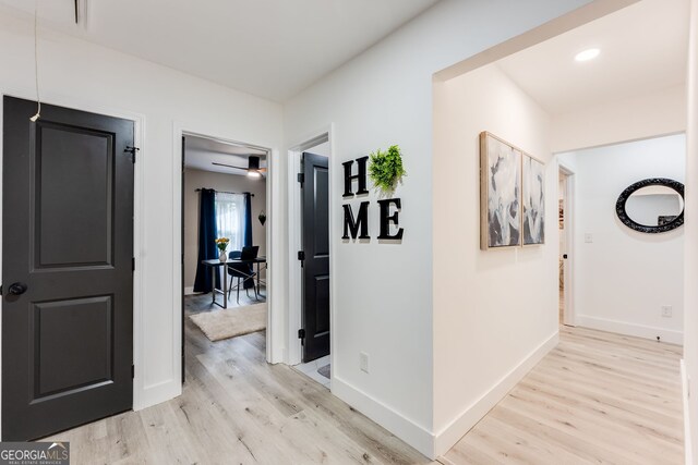 hall with light hardwood / wood-style floors