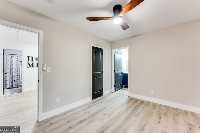 unfurnished bedroom featuring light hardwood / wood-style floors, ceiling fan, and ensuite bathroom