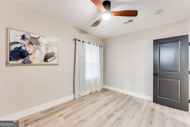 unfurnished room with ceiling fan, light hardwood / wood-style flooring, and lofted ceiling