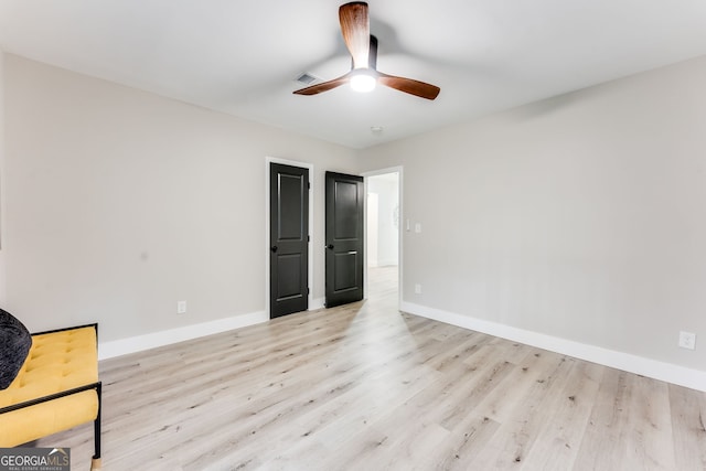 interior space with ceiling fan and light wood-type flooring