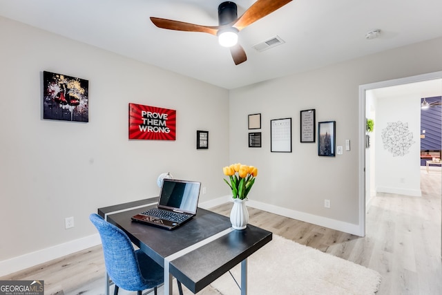 office area with light hardwood / wood-style flooring and ceiling fan