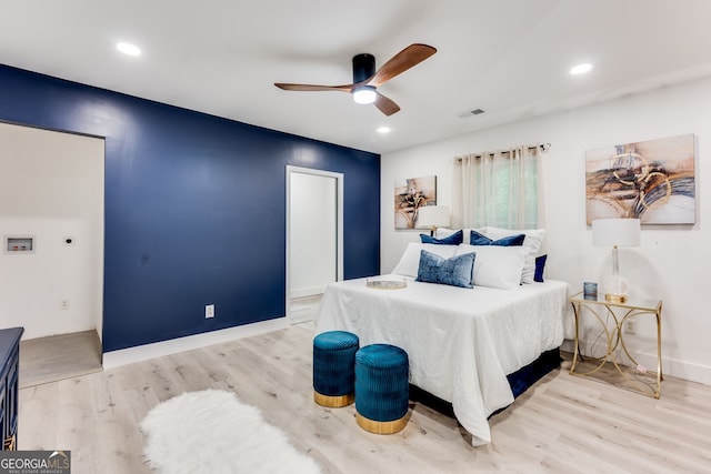 bedroom featuring ceiling fan and light hardwood / wood-style flooring