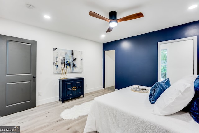 bedroom with ceiling fan and light wood-type flooring