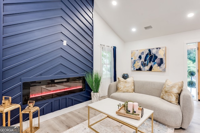 living room featuring hardwood / wood-style floors and lofted ceiling