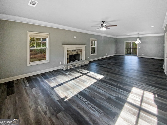 unfurnished living room featuring ceiling fan, a fireplace, crown molding, and dark wood-type flooring