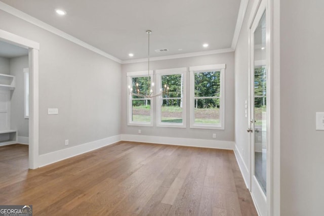 interior space featuring light hardwood / wood-style floors, an inviting chandelier, and ornamental molding