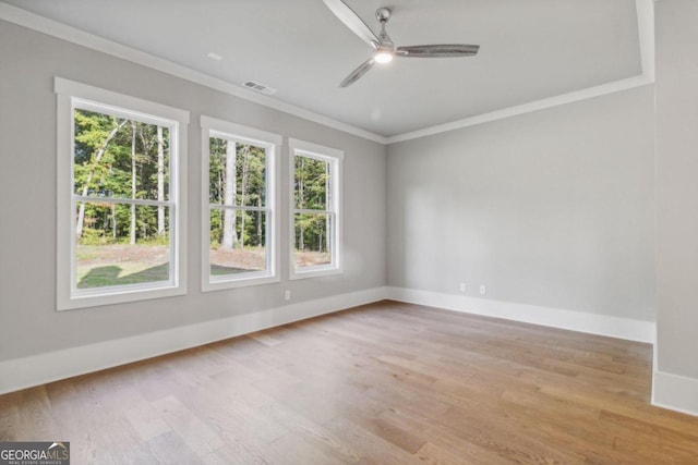 unfurnished room featuring light wood-type flooring, ceiling fan, and ornamental molding