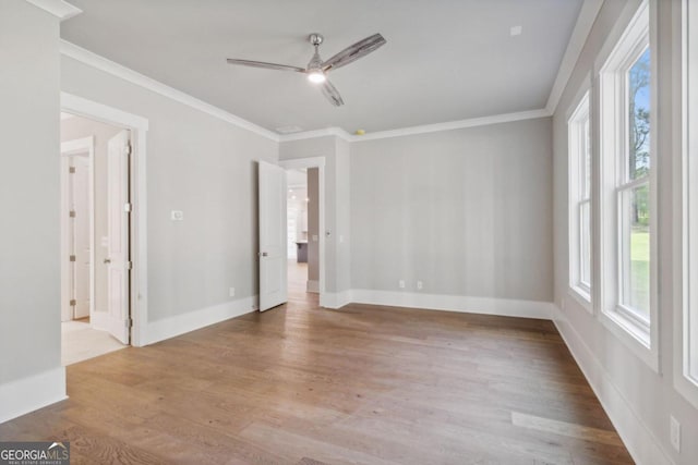 unfurnished room with light hardwood / wood-style floors, ceiling fan, and crown molding