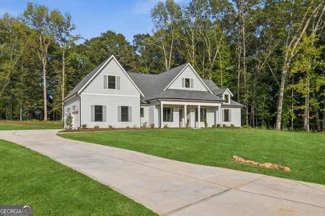 view of front of house with a porch and a front yard