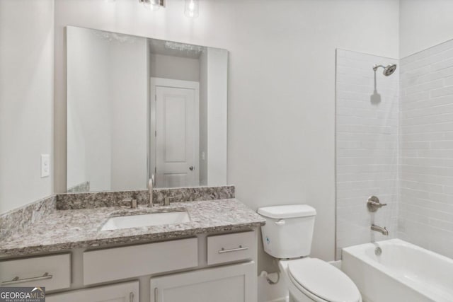 full bathroom with vanity, tiled shower / bath combo, and toilet