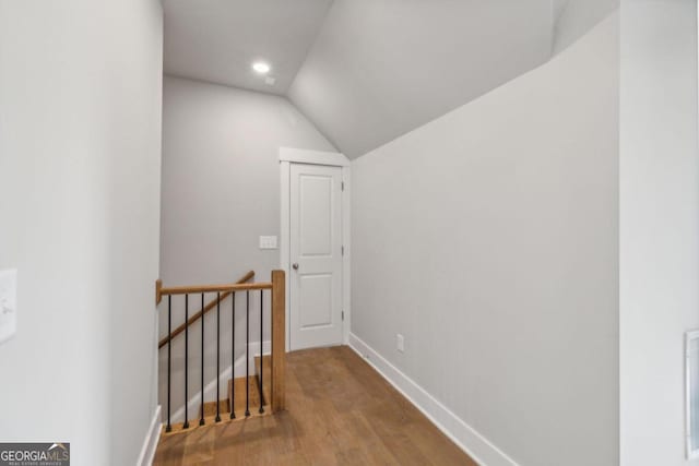 bonus room with hardwood / wood-style floors and vaulted ceiling