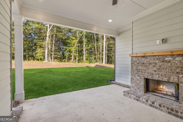 view of patio / terrace with an outdoor brick fireplace and ceiling fan