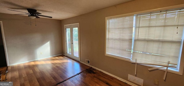 spare room featuring ceiling fan, french doors, hardwood / wood-style floors, and a textured ceiling