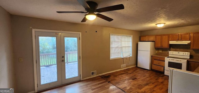 kitchen with ceiling fan, french doors, dark hardwood / wood-style floors, a textured ceiling, and white appliances