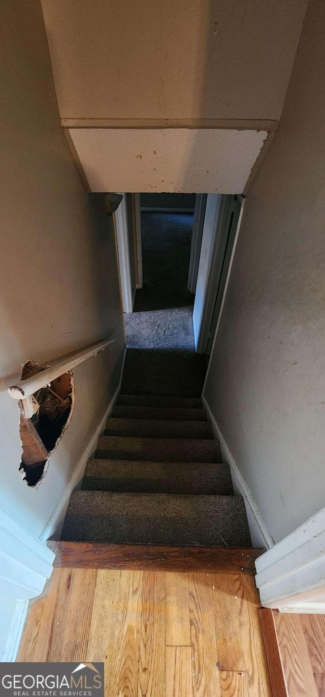 stairs with hardwood / wood-style floors